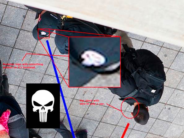 Craft mercenaries on the scene at the Boston Marathon, their hats bearing the company&#039;s logo, magnified here